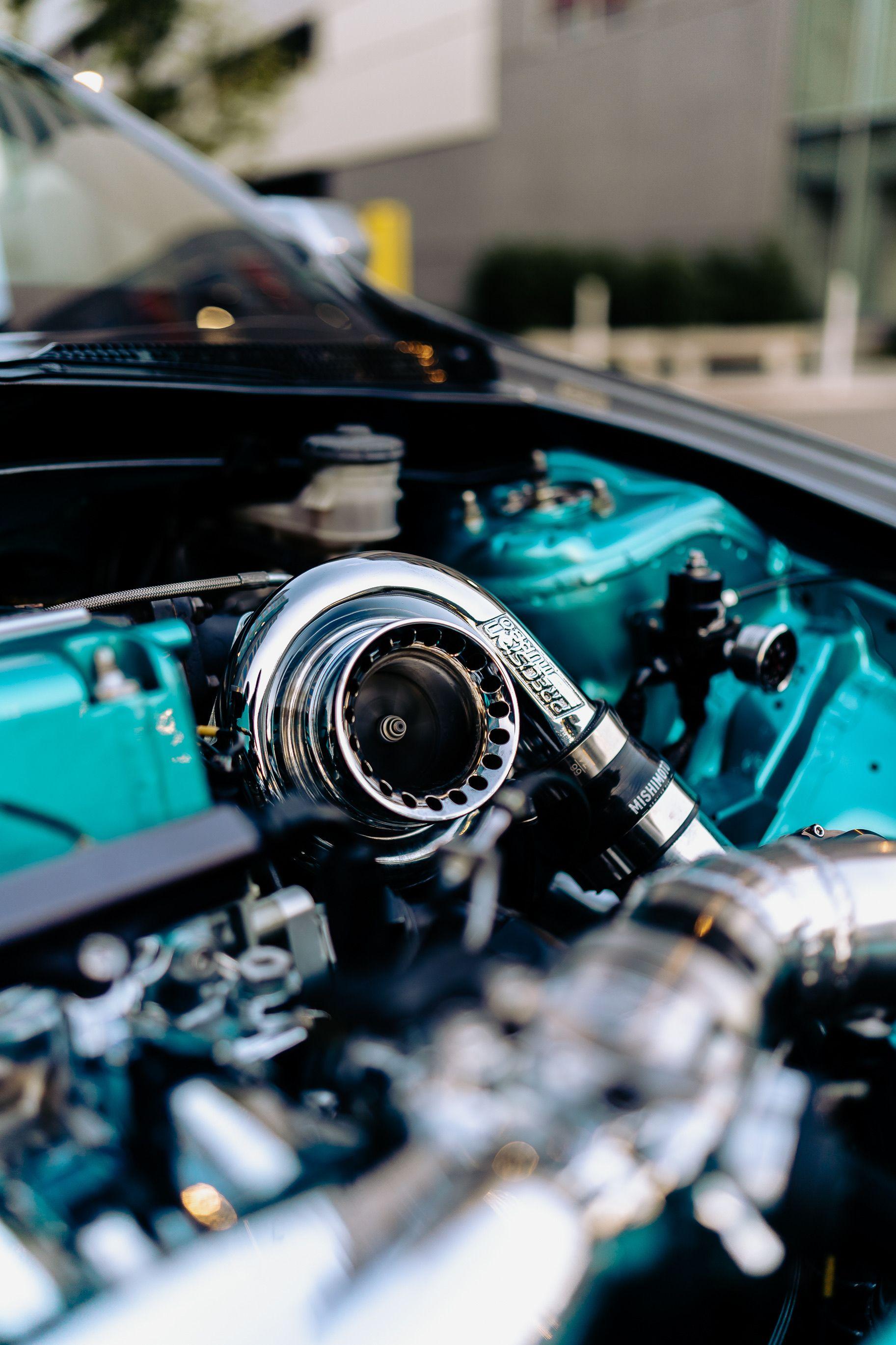 Turquoise engine bay with a polished chrome turbocharger and intercooler piping